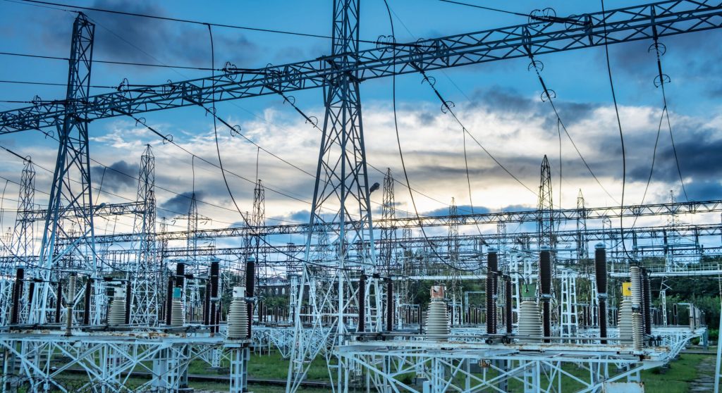 Sunset behind substation towers with blue sky Photo
