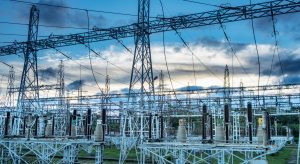 Sunset behind substation towers with blue sky Photo